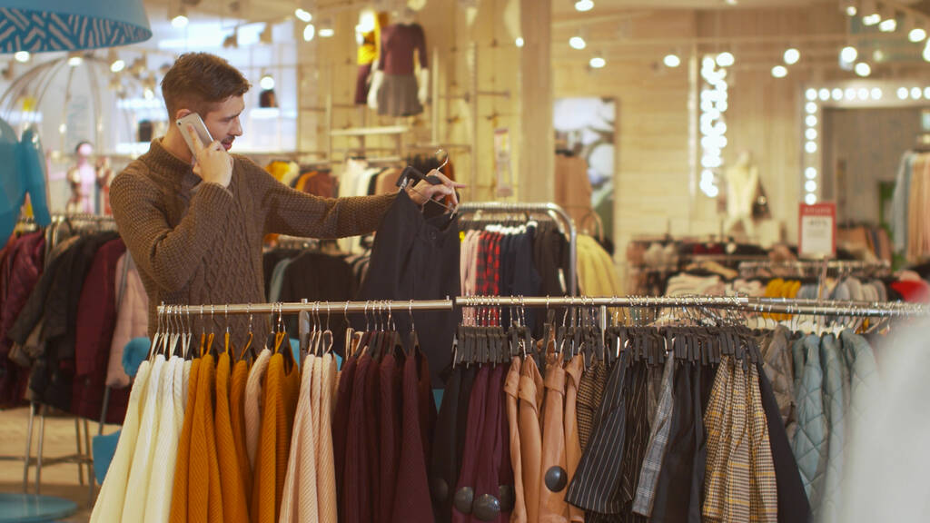 Man discusses the choice of women's clothing on the phone